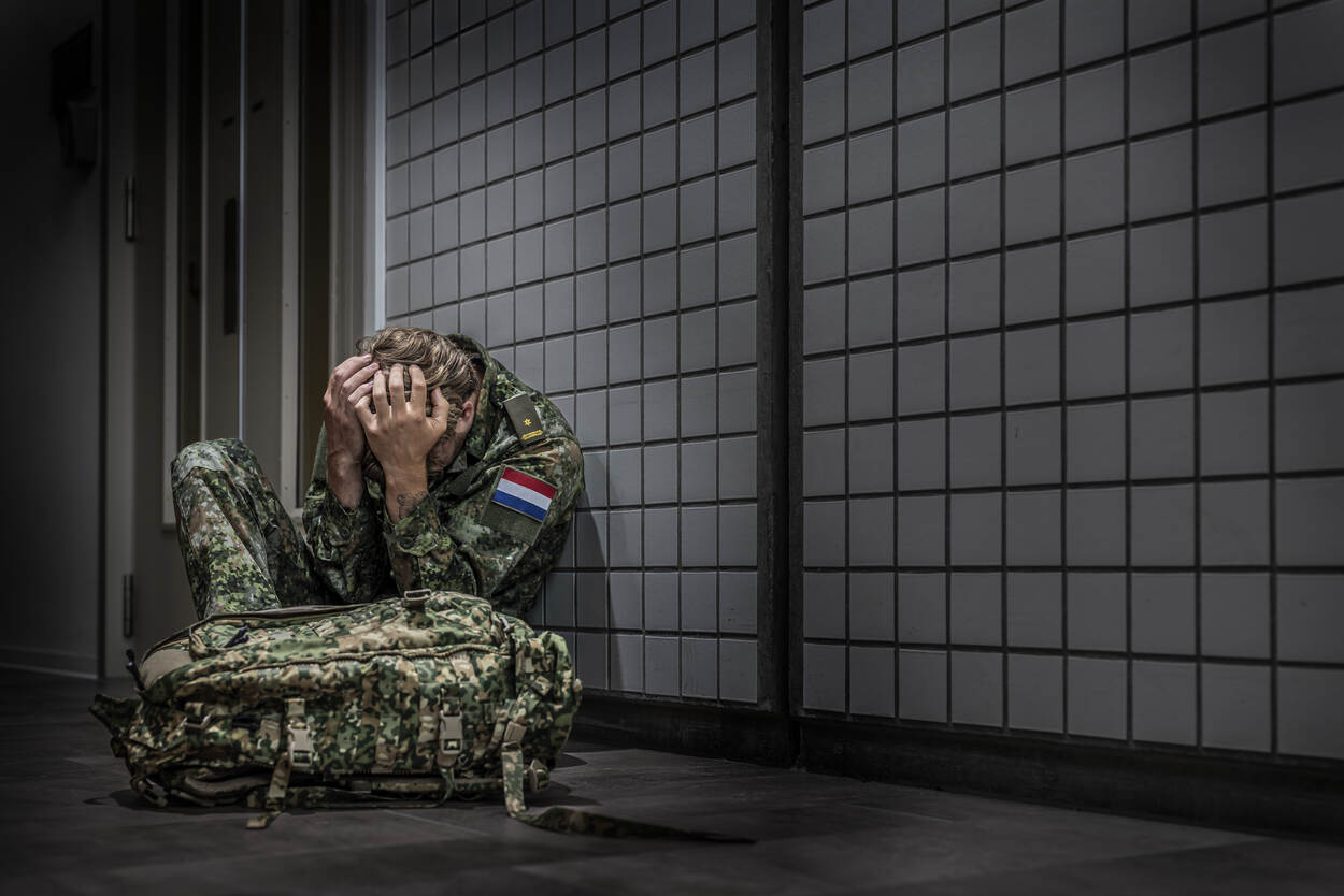 IN DEPTH banner; military personnel who buries face in hands
